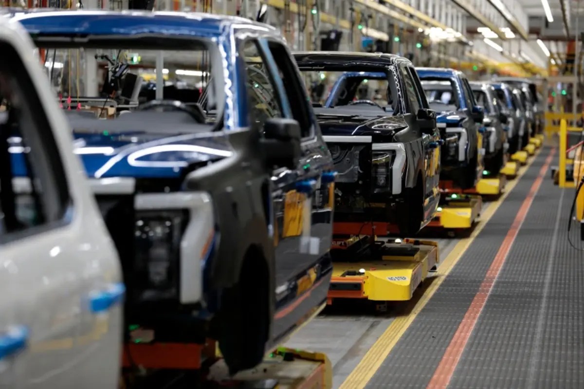 Workers assemble Ford vehicles