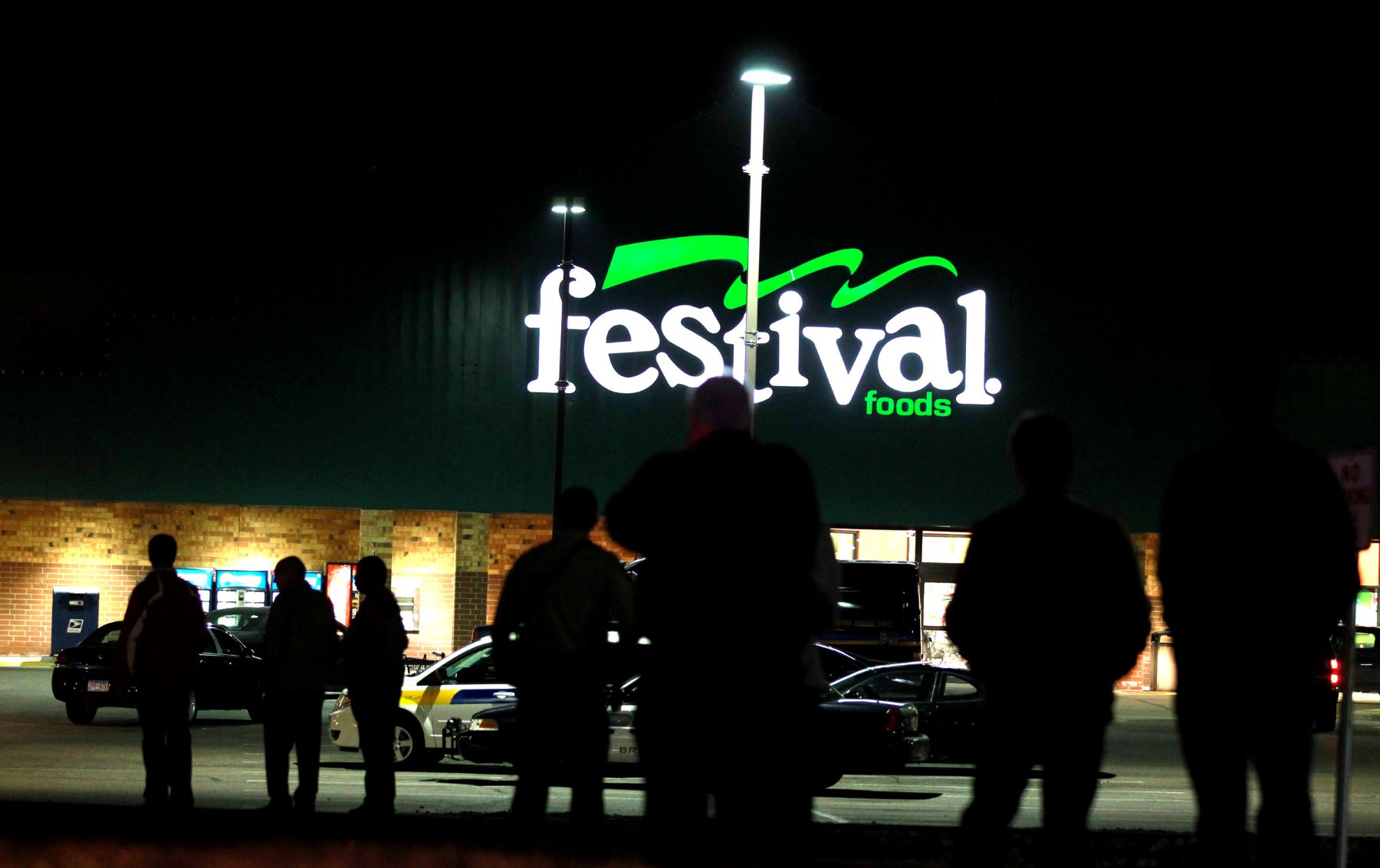 A Festival Foods grocery store parking lot at night in Brooklyn Park, Minnesota
