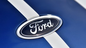 A Ford logo on a blue background with a white background, which Ford violating franchise law