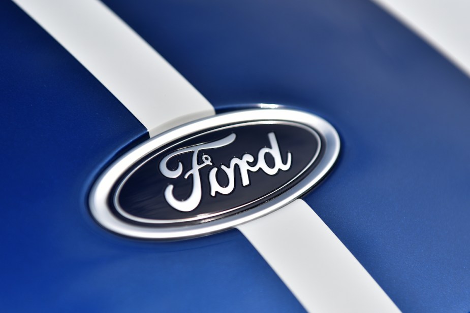 A Ford logo on a blue background with a white background, which Ford violating franchise law