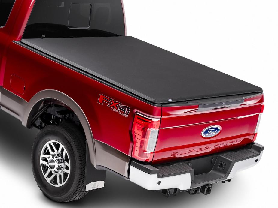 A red Ford pickup with a tonneau cover on the cargo bed.  There are a few reasons to buy one.