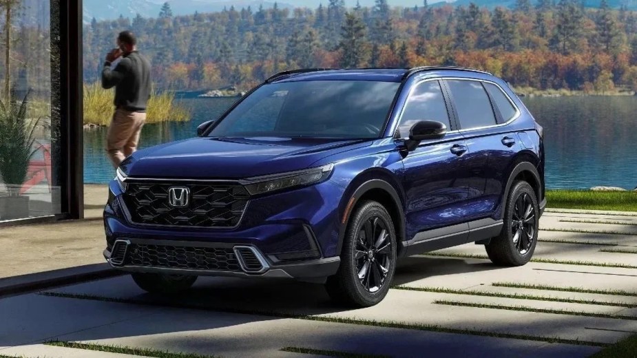 Front angle view of blue 2023 Honda CR-V Sport Touring Hybrid crossover SUV