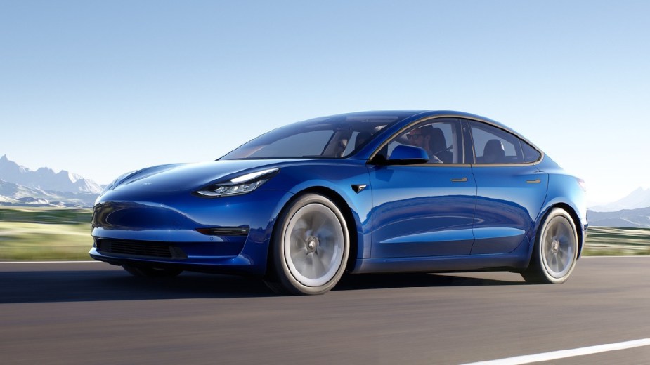 Front angle view of blue 2023 Tesla Model 3, cheapest new Tesla and world’s best-selling electric car