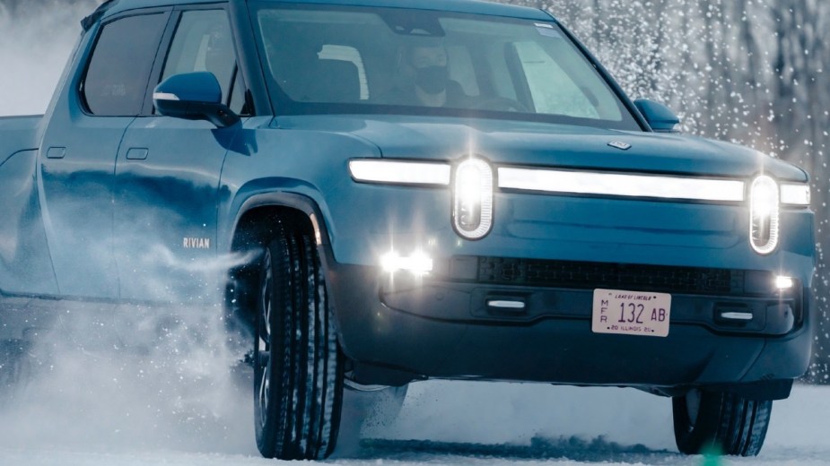 Front angle view of blue Rivian R1T EV truck, the best pickup truck for driving in the snow
