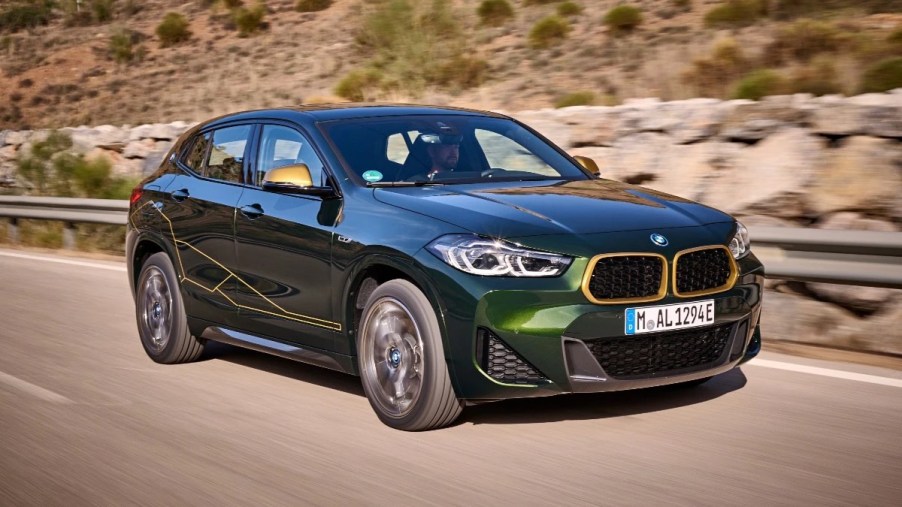 Front angle view of green 2023 BMW X2 small luxury SUV, the cheapest new BMW car