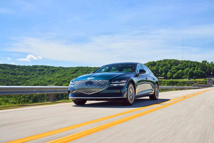 A Genesis Electrified G80 driving down the road. The G80 is one of the better Genesis sales stories from 2022.