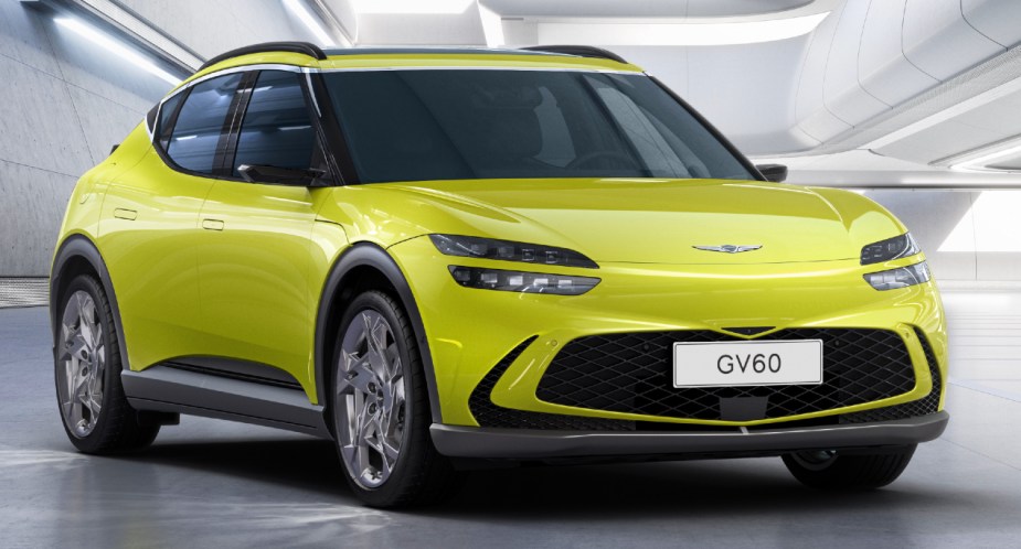 A green 2023 Genesis GV60 small electric SUV is parked. 