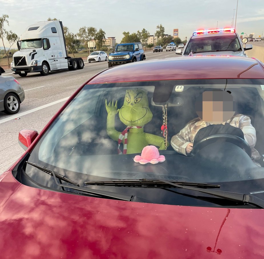 Cops pulled over an inflatable grinch holiday decoration riding in the passenger seat of an Arizona man's vehicle
