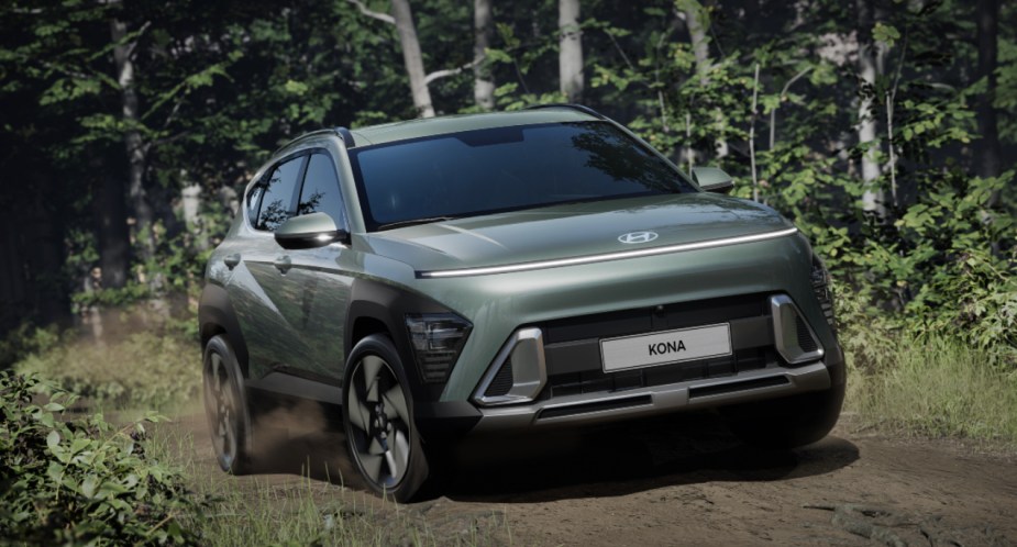 A green 2024 Hyundai Kona subcompact SUV drives off-road. 