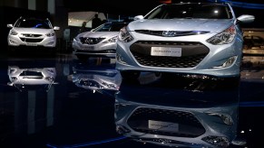 3 Hyundai Sonatas indoors with a black background.