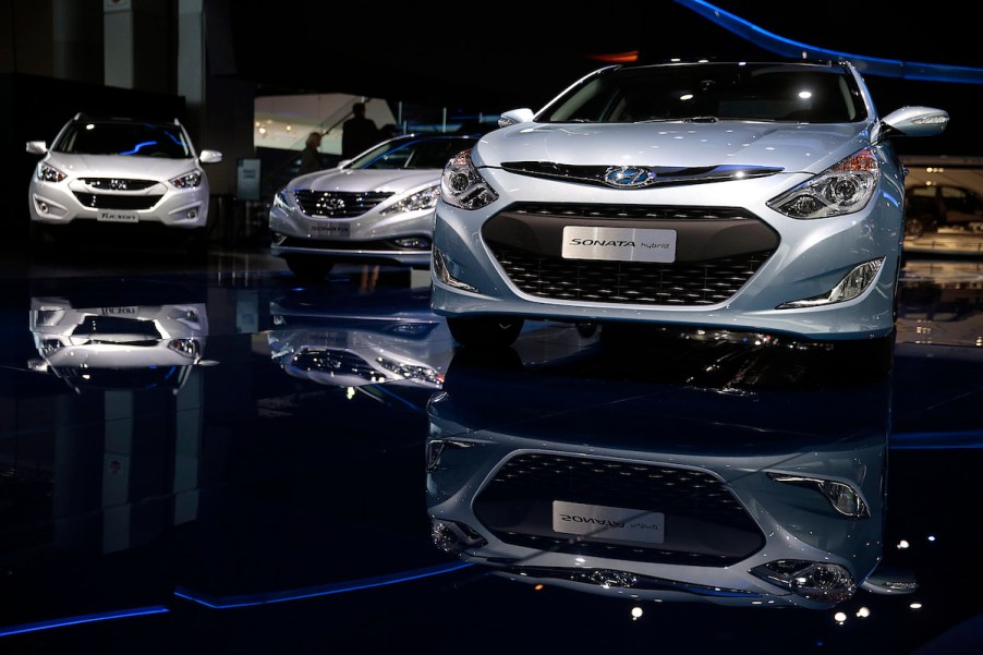 3 Hyundai Sonatas indoors with a black background.