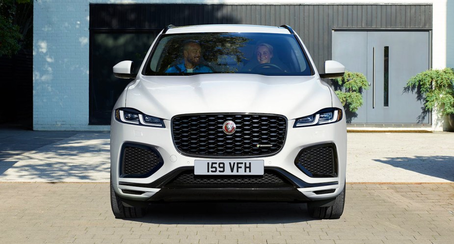 A white 2022 Jaguar F-PACE small luxury performance SUV is parked. 