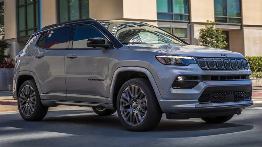 A gray 2023 Jeep Compass small SUV is parked.