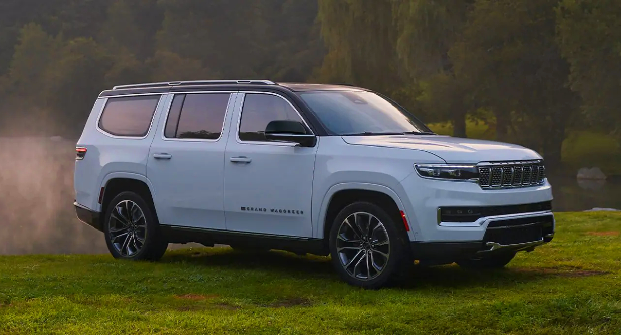 A white 2023 Jeep Grand Wagoneer large luxury SUV is parked. 