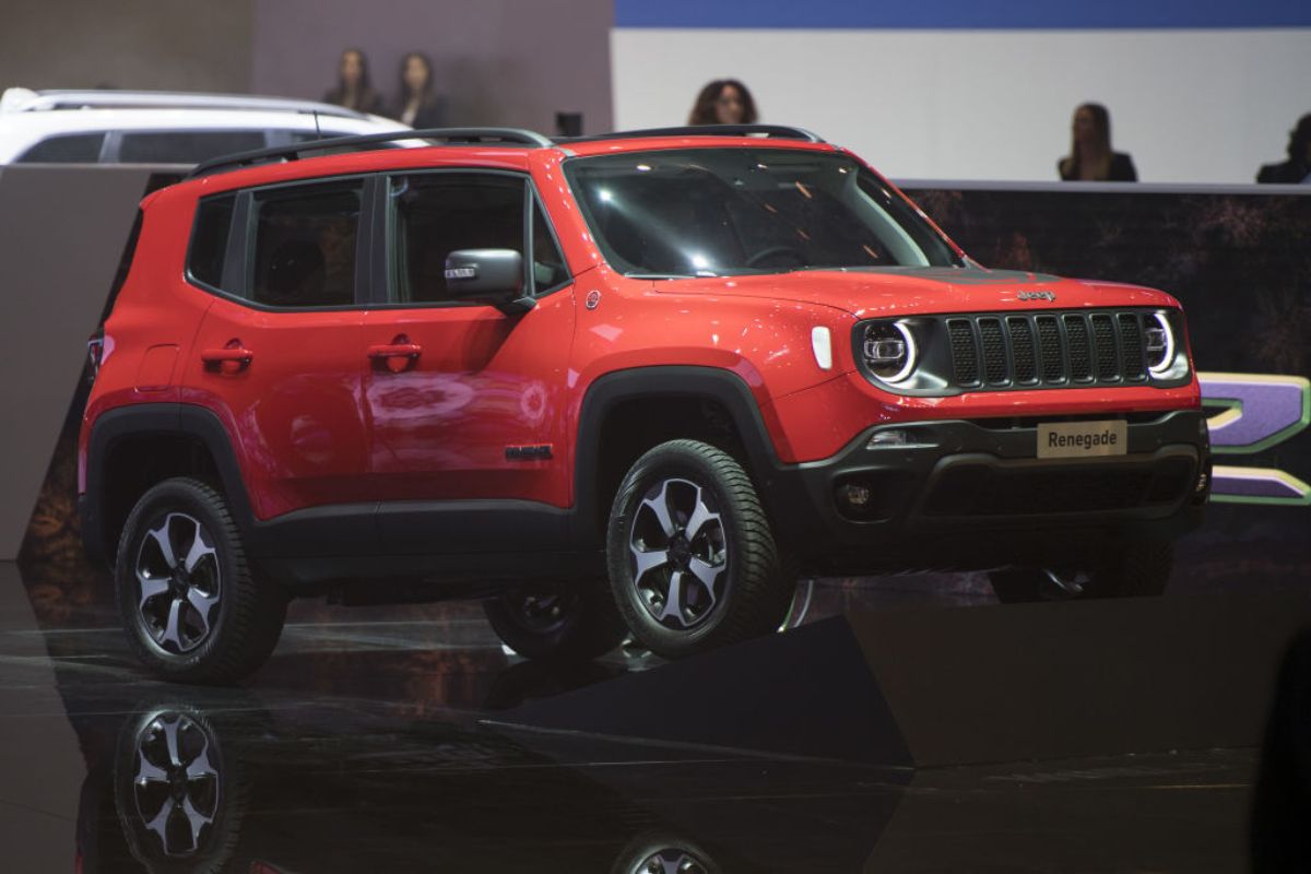 A red Jeep Renegade on display at an auto show