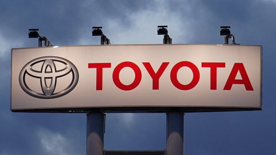 Lighted Toyota sign with dark clouds, highlighting how Toyota got its name