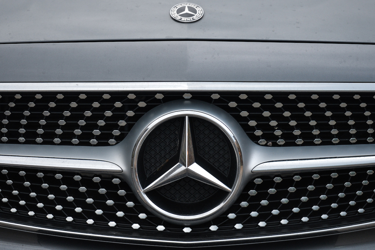 A Mercedes-Benz logo on the front of a car.
