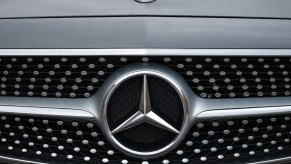 A Mercedes-Benz logo on the front of a car.