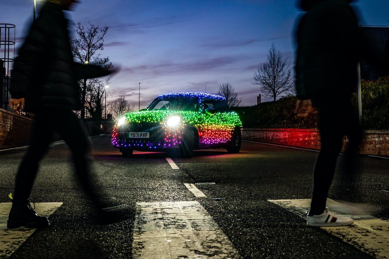 A Mini Cooper covered in Christmas lights.
