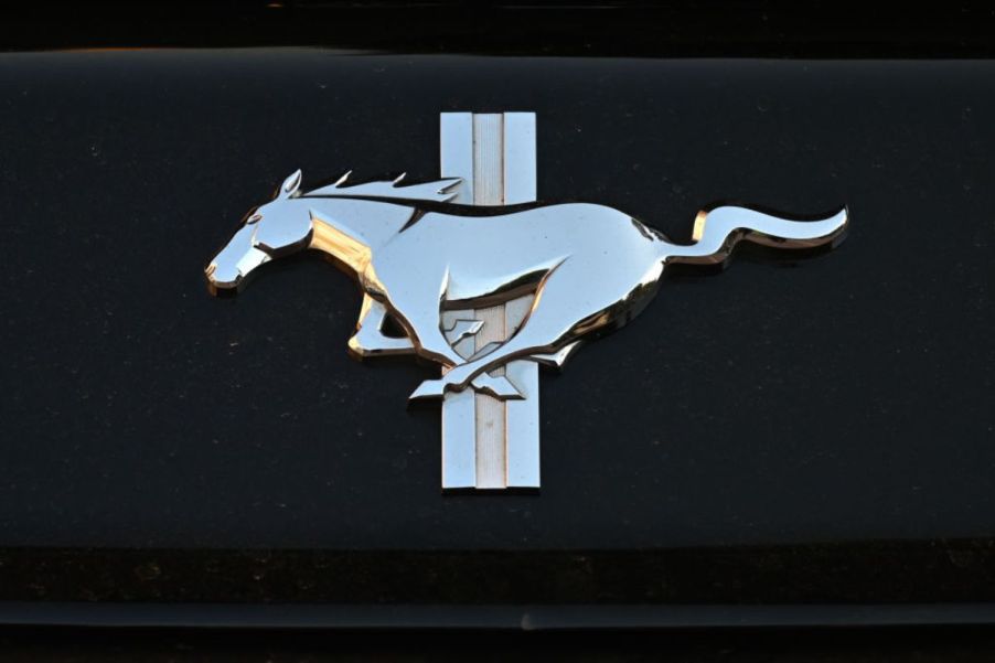 A silver Ford Mustang logo over a black background.