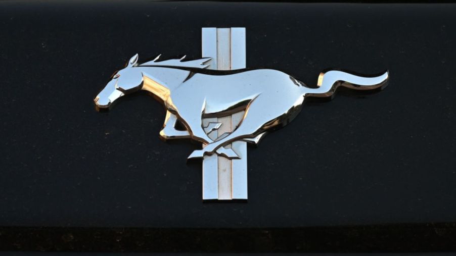 A silver Ford Mustang logo over a black background.