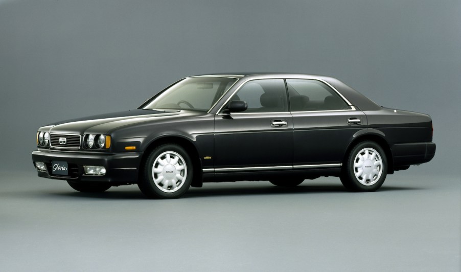 A black Nissan Gloria against a grey background.