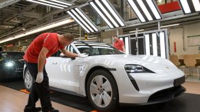 A vehicle fit-and-finish and reliability inspection of a Porsche Taycan electric sports car in Stuttgart, Germany
