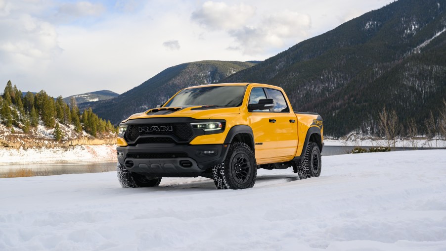 a yellow 2023 Ram 1500 TRX Havoc Editon parked in the snow in Baja Yellow.