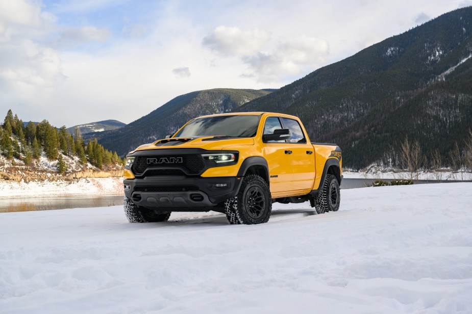 a yellow 2023 Ram 1500 TRX Havoc Edition parked in the snow in Baja Yellow.