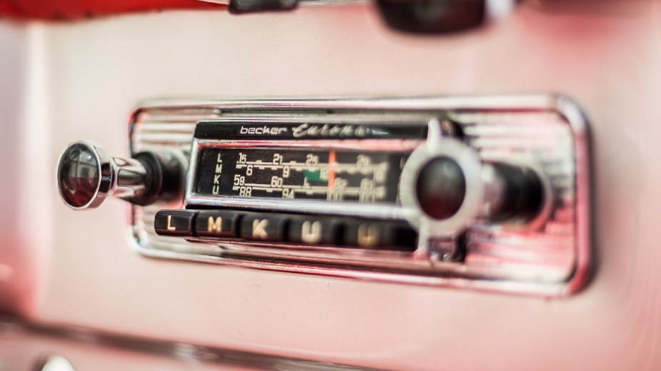 Radio in pink classic car, highlighting how electric cars could kill AM radio