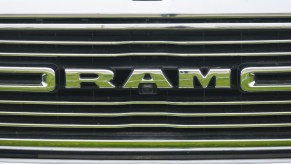 Closeup of the chrome grille of a pickup truck, the work RAM visible.