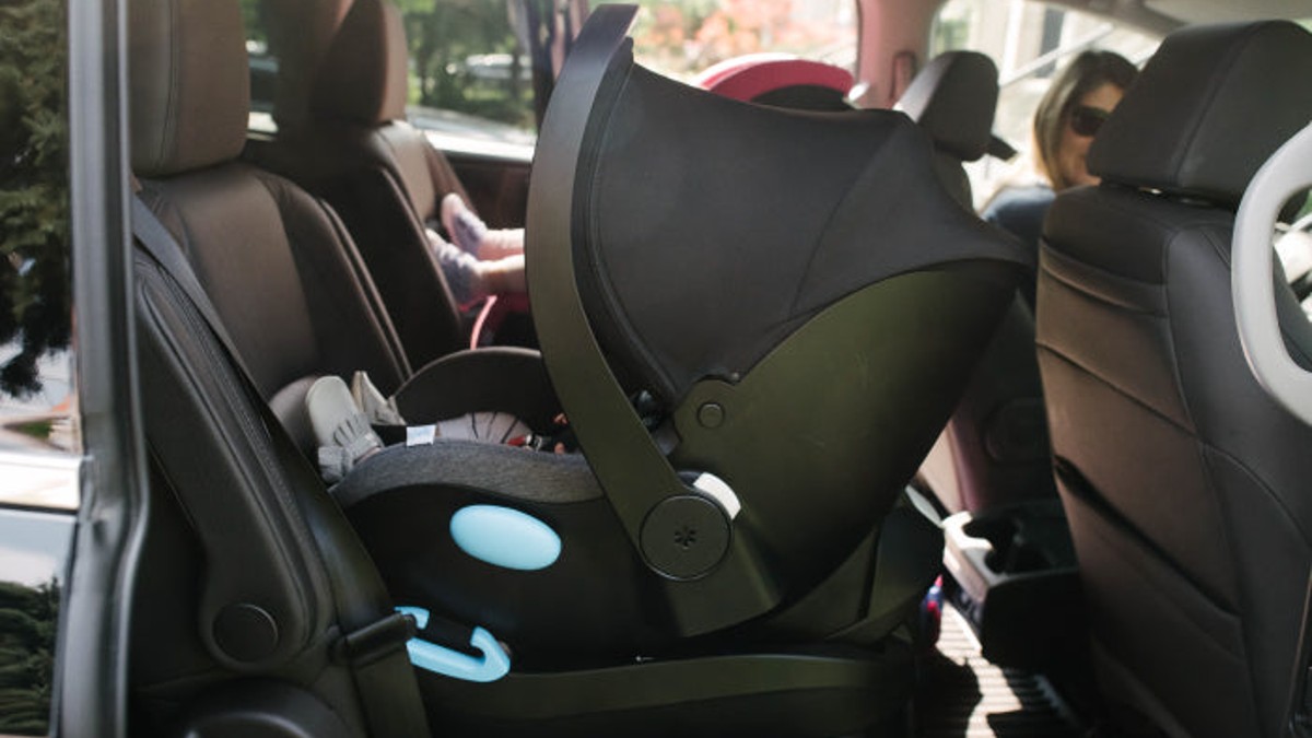 A rear-facing infant seat in a car.