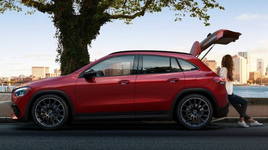 Red 2023 Mercedes GLA 250 parked next to a treee