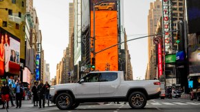 White Rivian R1T electric pickup truck parked in Times Square, New York City for the company's Wall Street stock exchange IPO.