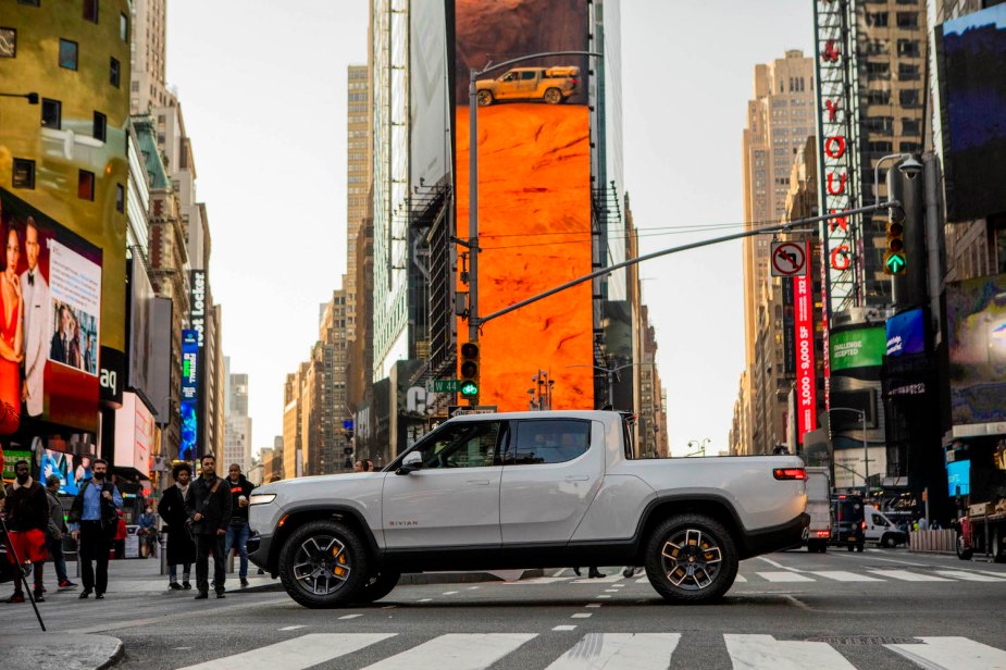 White Rivian R1T electric pickup truck parked in Times Square, New York, for the company's Wall Street IPO.