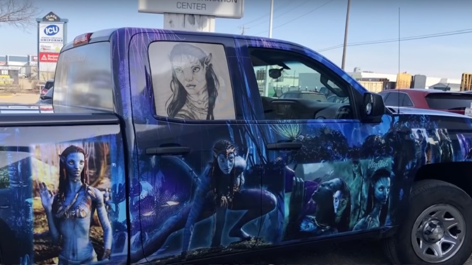 Side view of Avatar-themed pickup truck that tattooed “Mr. Avatar” man drives