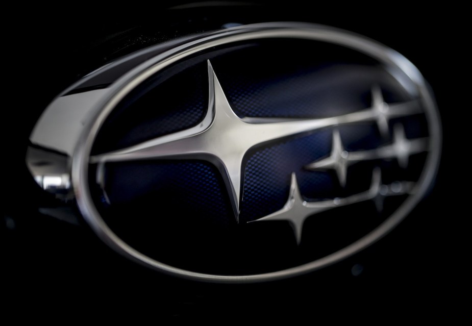 Closeup photo of the Subaru logo with its Pleiades Seven Sisters constellation.