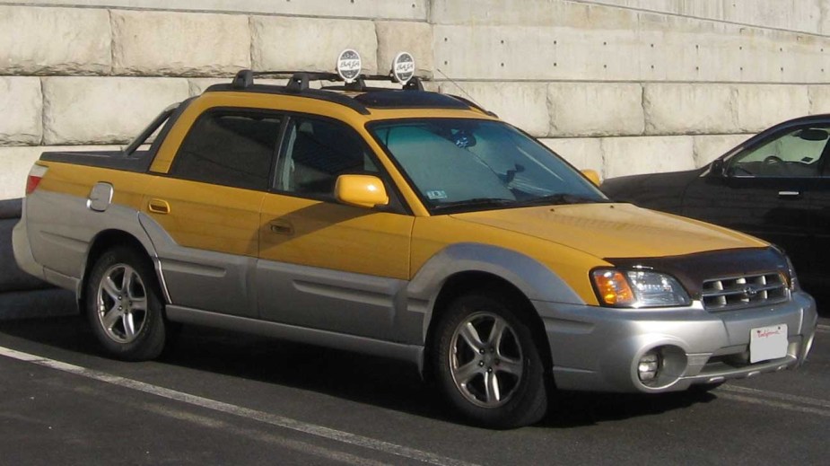 A yellow Subaru Baja, a small truck by the Japanese automaker.