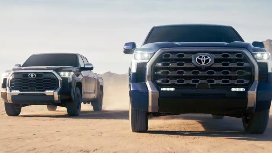 Two Toyota Tundra models driving on a dirty road. A used Toyota Tundra is still great value