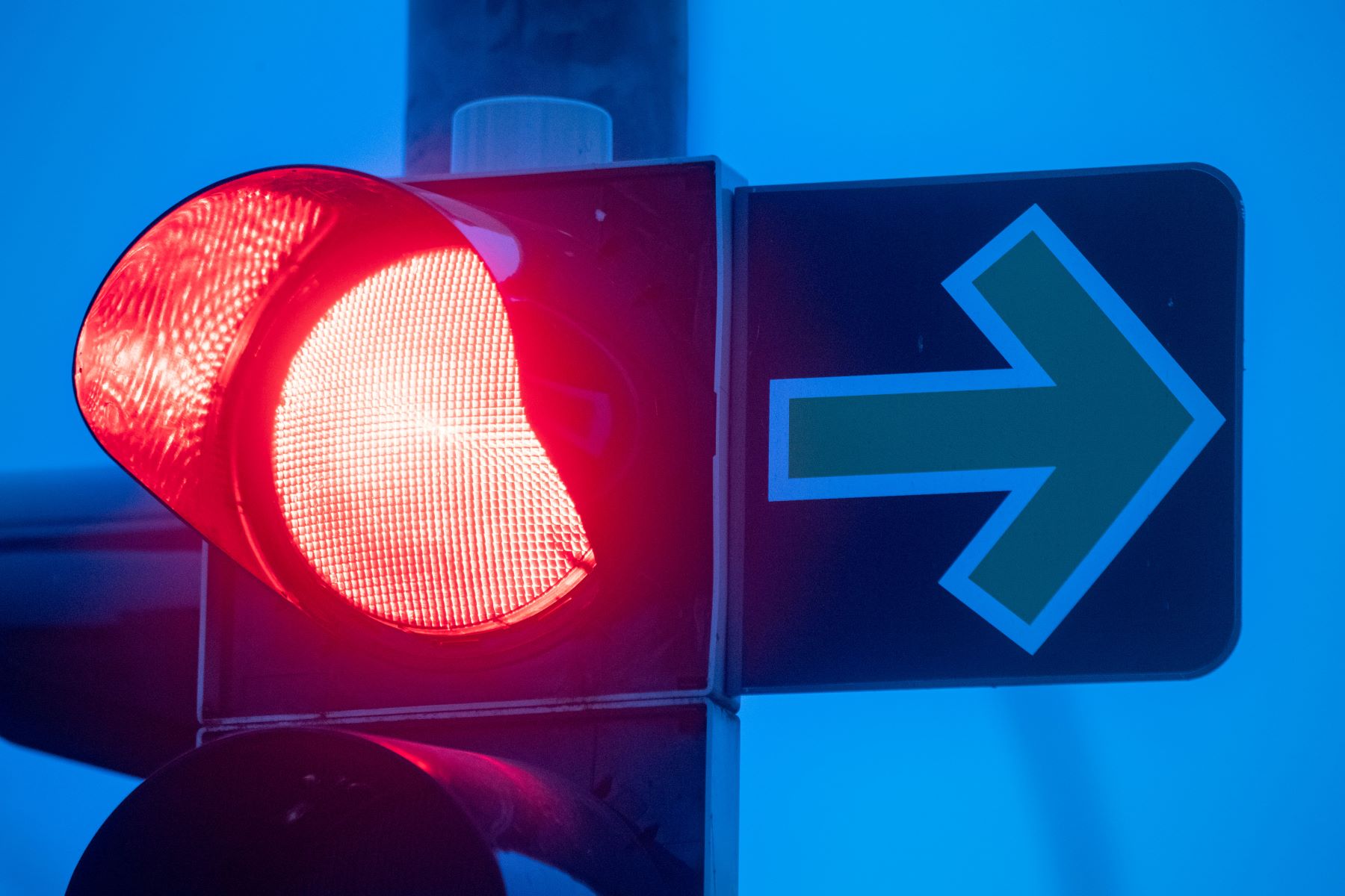 A red traffic light with a green arrow sign in the early morning in Mecklenburg-Western Pomerania, Stralsund