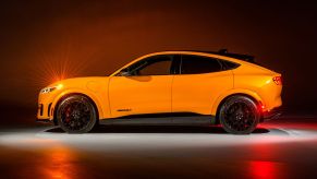 A yellow-gold 2023 Ford Mustang Mach-E GT Performance Edition compact electric SUV with the Nite Pony Package