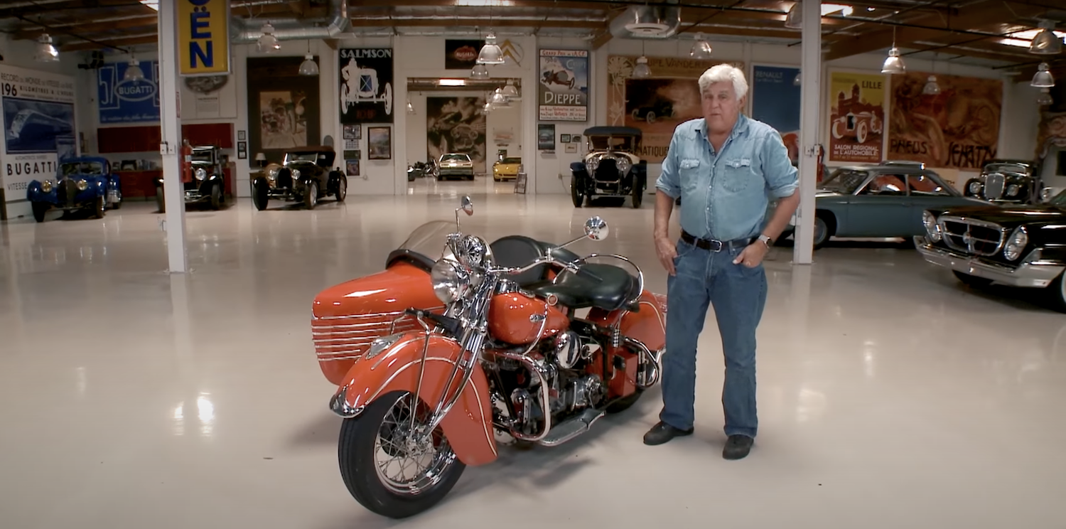 Jay Leno stands next to the 1940 Indian motorcycle he crashed in January 2023