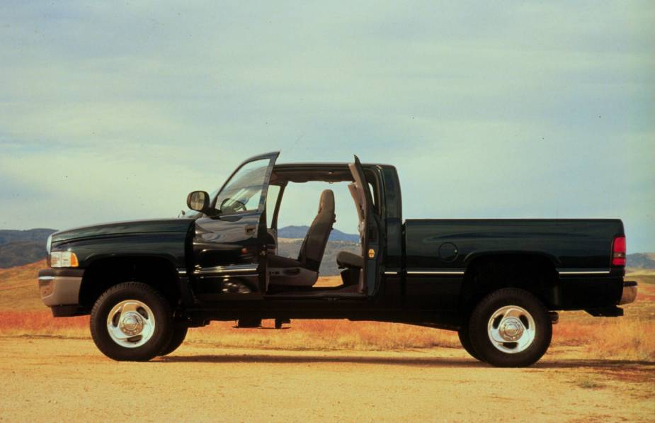 Black 1998 Dodge Ram pickup truck with its rear-hinged clamshell doors open to show off its quad cab rear seat.
