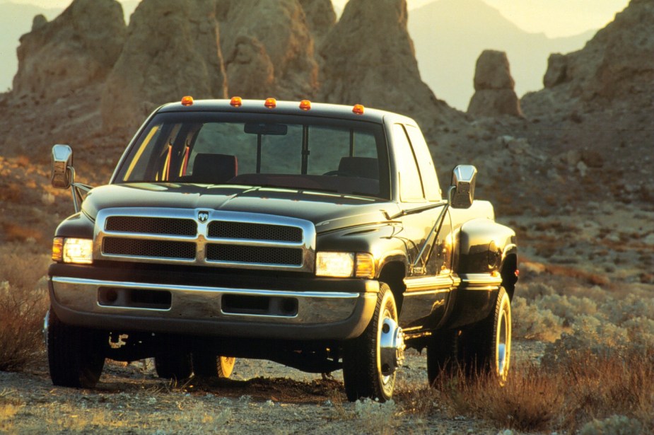 A dually, heavy-duty Dodge Ram pickup truck with chrome trailering mirrors.