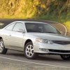 A 2003 Toyota Solara driving down road.