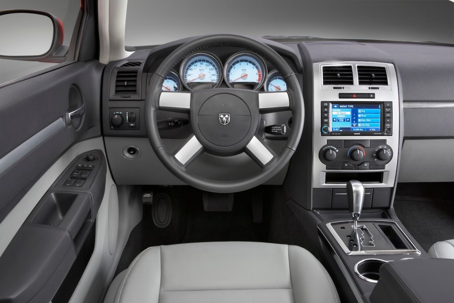 The gray and black interior of a 2010 Dodge Charger sedan.
