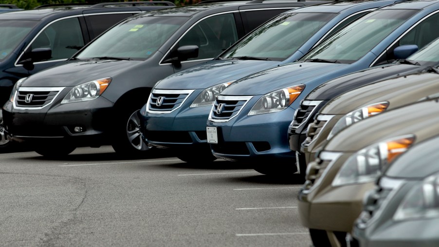 2010 Honda Odyssey minivan models in a used car lot somewhere in 2010.