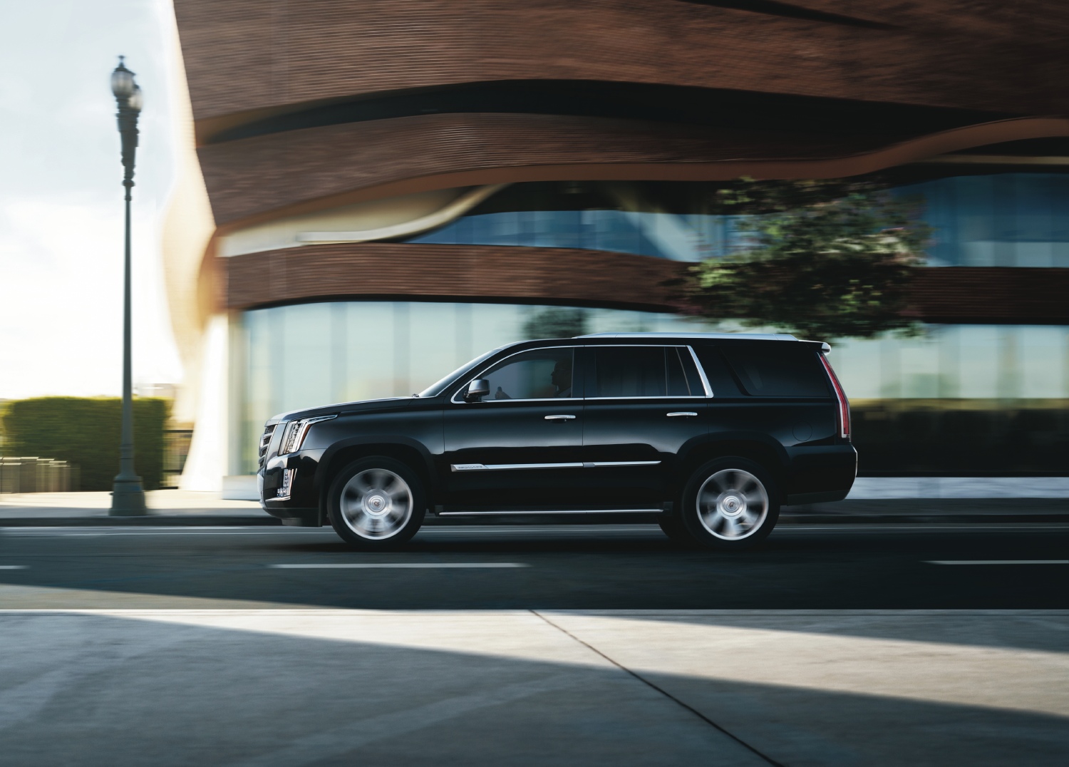 A 2015 Cadillac Escalade driving on the road