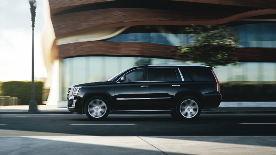 A 2015 Cadillac Escalade driving on the road