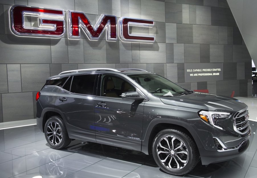 2017 GMC Terrain parked indoors in front of the GMC logo.